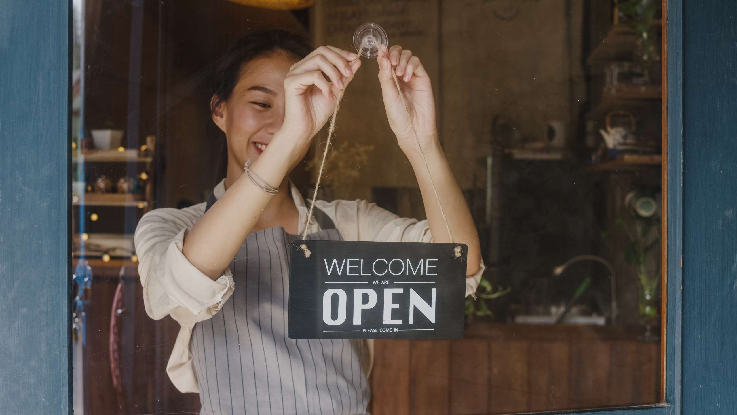 Business owner changing a sign to open